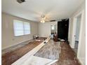 Spacious living room with a fireplace and large windows, ready for renovation with partially installed floors at 2791 Neill Rd, Lancaster, SC 29720