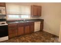 Functional kitchen featuring ample cabinetry, standard appliances, and a well-lit window at 327 Bonview Ave, Lincolnton, NC 28092