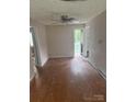 Living room features wood floors, ceiling fan and access to back yard at 341 Talley St, Troutman, NC 28166