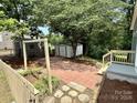 Spacious backyard patio area with a brick paver and landscaping at 408 N Hill St, Dallas, NC 28034