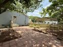 Paver patio leading to a carport structure and fenced-in yard at 408 N Hill St, Dallas, NC 28034