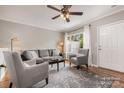 Inviting living room featuring neutral tones, a plush sofa, and a bright window at 4124 Melrose Club Dr, Matthews, NC 28105
