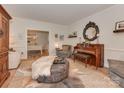 Inviting living room with stylish decor, including a piano, plush seating, and decorative ottoman at 4201 Quail Hunt Ln, Charlotte, NC 28226