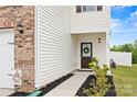 Home exterior features a brick accent wall and a charming front door with a decorative wreath at 449 Misty Law Ln, Clover, SC 29710