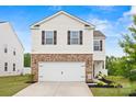 Charming two-story home with white siding, brick accents, dark shutters, and a two-car garage at 449 Misty Law Ln, Clover, SC 29710
