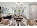 Bright living room featuring a sofa and two chairs in front of large windows at 4742 Lakeview N Rd # 17, Charlotte, NC 28216