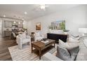 Open-concept living room showcasing kitchen, dining area, and comfortable seating arrangement at 4750 Lakeview N Rd # 18, Charlotte, NC 28216