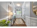 Charming hallway with hardwood floors, decorative table, and a view of the front door at 5088 Watersail Way, Clover, SC 29710