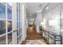 Elegant hallway featuring hardwood floors, decorative accents, and a view into the living areas at 5088 Watersail Way, Clover, SC 29710