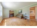 Bright living room with hardwood floors, a fireplace, and a comfortable sofa at 5840 Potter Rd, Matthews, NC 28104