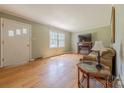 Cozy living room featuring hardwood floors and a charming fireplace at 5840 Potter Rd, Matthews, NC 28104
