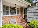 Inviting front porch with brick steps and a charming hanging lantern at 607 Coulwood Dr, Charlotte, NC 28214