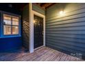 A warm welcome at the front door of the unit, featuring stylish wooden accents and a well-lit entrance at 623 Olmsted Park Pl # D, Charlotte, NC 28203