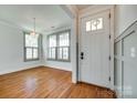 Inviting home foyer with hardwood floors, chandelier and a decorative front door at 750 Waterscape Ct, Rock Hill, SC 29730