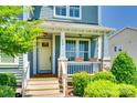 Inviting front porch with beautiful landscaping, brick accents, and a cheerful yellow door at 750 Waterscape Ct, Rock Hill, SC 29730