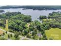 Aerial view of the property and surrounding neighborhood showing lake access and wooded areas at 8506 Graham Rd, Denver, NC 28037