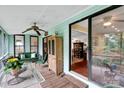Cozy screened-in porch with comfortable seating and view into the dining room at 8506 Graham Rd, Denver, NC 28037