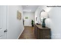 Hallway with wood floors, a decorative console table, and a view of the front door at 925 Two Brothers Ln, York, SC 29745