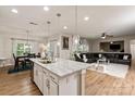 Bright, open-concept kitchen and living room area; the kitchen has a spacious island with bar stool seating at 10044 Markus Dr, Mint Hill, NC 28227