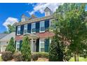 Beautiful two-story brick home with lush landscaping in a residential neighborhood at 1025 N Sharon Amity Rd, Charlotte, NC 28211