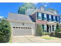 Side view of the house showing the garage and partial front elevation at 1025 N Sharon Amity Rd, Charlotte, NC 28211