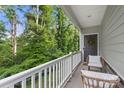 Inviting covered porch with chairs and view of the greenery at 1028 Maltby St, Charlotte, NC 28217