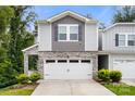Charming two-story home with stone accents, neutral siding, and a two car garage at 1028 Maltby St, Charlotte, NC 28217