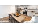 A contemporary kitchen with stainless steel appliances and a center dining table at 1035 20Th Avenue Se Loop, Hickory, NC 28602