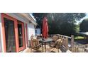 Outdoor deck furnished with a table, umbrella, and chairs for comfortable outdoor entertaining at 105 N Central Ave, Belmont, NC 28012