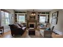 Inviting living room featuring a cozy fireplace, built-in bookshelves, and ample natural light at 105 N Central Ave, Belmont, NC 28012
