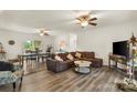 Open-concept living room with a large sectional sofa, dining area, and modern flooring at 113 Robinette Ln, Statesville, NC 28625