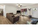 Bright living room featuring a comfortable sofa, stylish decor, and a large window offering natural light at 113 Robinette Ln, Statesville, NC 28625