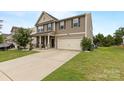 Charming two-story home with a large driveway and well-manicured lawn at 116 Maggie Dr, Mount Holly, NC 28120