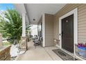 Cozy front porch with stone pillars and seating area at 116 Maggie Dr, Mount Holly, NC 28120