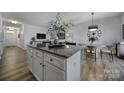 Open-concept kitchen featuring a granite island, modern appliances, and seamless access to the dining area at 149 Briana Marie Way, Indian Trail, NC 28079