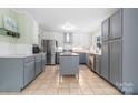 Bright, updated kitchen featuring stainless steel appliances, a kitchen island, and stylish gray and white cabinetry at 1525 16Th Avenue Nw Cir, Hickory, NC 28601