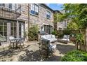 Private stone patio perfect for outdoor dining and lounging with grill and mature landscaping at 1625 Bibury Ln, Charlotte, NC 28211