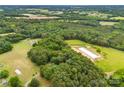 Expansive aerial view of a lush, green property with trees and open land at 16453 Nc Hwy 73 Hwy, Albemarle, NC 28001