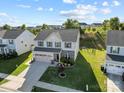 Aerial view of a beautiful two-story home featuring a well-maintained lawn and three-car garage at 1725 Mill Creek Sw Ln, Concord, NC 28025