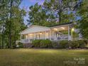 Inviting covered porch with white railings overlooking a well-manicured lawn at 17835 Terryglass Ln, Charlotte, NC 28278