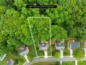 Aerial shot showcases the property's expansive lot with mature trees and its location within a residential community at 200 Winter Flake Dr, Statesville, NC 28677