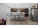 Kitchen with stainless steel appliances, a kitchen island with seating, and modern pendant lights at 2023 Puddle Pond Rd, Indian Trail, NC 28079