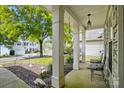 Inviting covered porch with decorative columns and outdoor seating, offering a relaxing view of the neighborhood at 2324 Oakdale Creek Ln, Charlotte, NC 28216