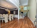 Elegant dining room featuring hardwood floors, a chandelier, and a table set for eight at 2406 Tarleton Twins Ter, Charlotte, NC 28270