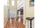 Bright foyer featuring hardwood floors, stairs, high ceilings, and an open view to the dining room at 2406 Tarleton Twins Ter, Charlotte, NC 28270