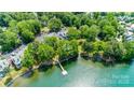 Beautiful aerial view of the lakefront condos with a private pier and lush green trees at 302 Northwest Dr, Davidson, NC 28036