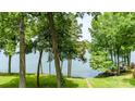 Scenic view of a backyard leading to the water, perfect for enjoying nature and lake access at 302 Northwest Dr, Davidson, NC 28036