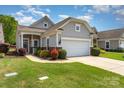 Charming single-story home boasts a two-car garage, manicured lawn, and an inviting entrance at 5141 Grandview Dr, Fort Mill, SC 29707