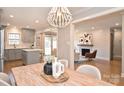 Open dining room with a view to a new kitchen and a living room with a fireplace and modern design at 532 Scaleybark Rd, Charlotte, NC 28209