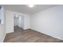 Spacious room featuring sleek floors, neutral walls, and a view into the entrance at 5343 Esther Ln, Charlotte, NC 28214